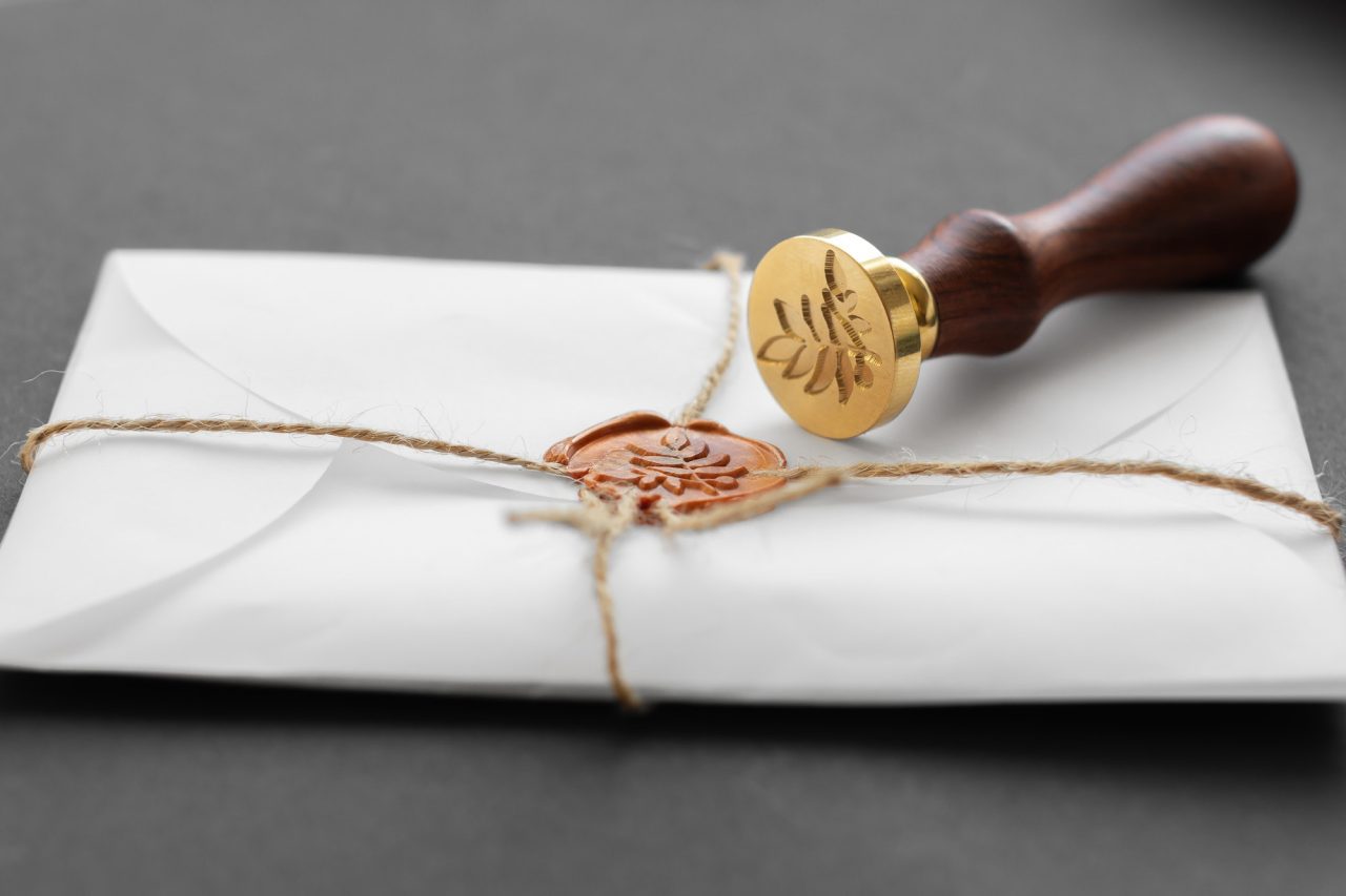 notary-public-wax-stamper-white-envelope-with-brown-wax-seal-golden-stamp-responsive-design